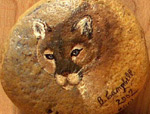 Painting of a cougar on a rock