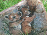 Painting of a koalas on a rock